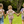 Three children holding hands with  bunny backpacks featuring cartoon characters outdoors.