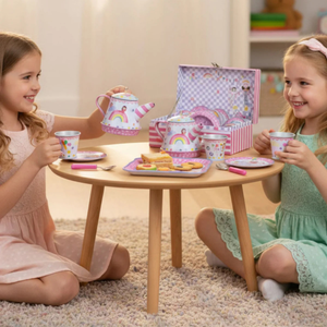 Two young girls playing with a toy tea set 